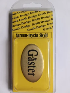 Skylt Gäster guld/svart 34x59mm